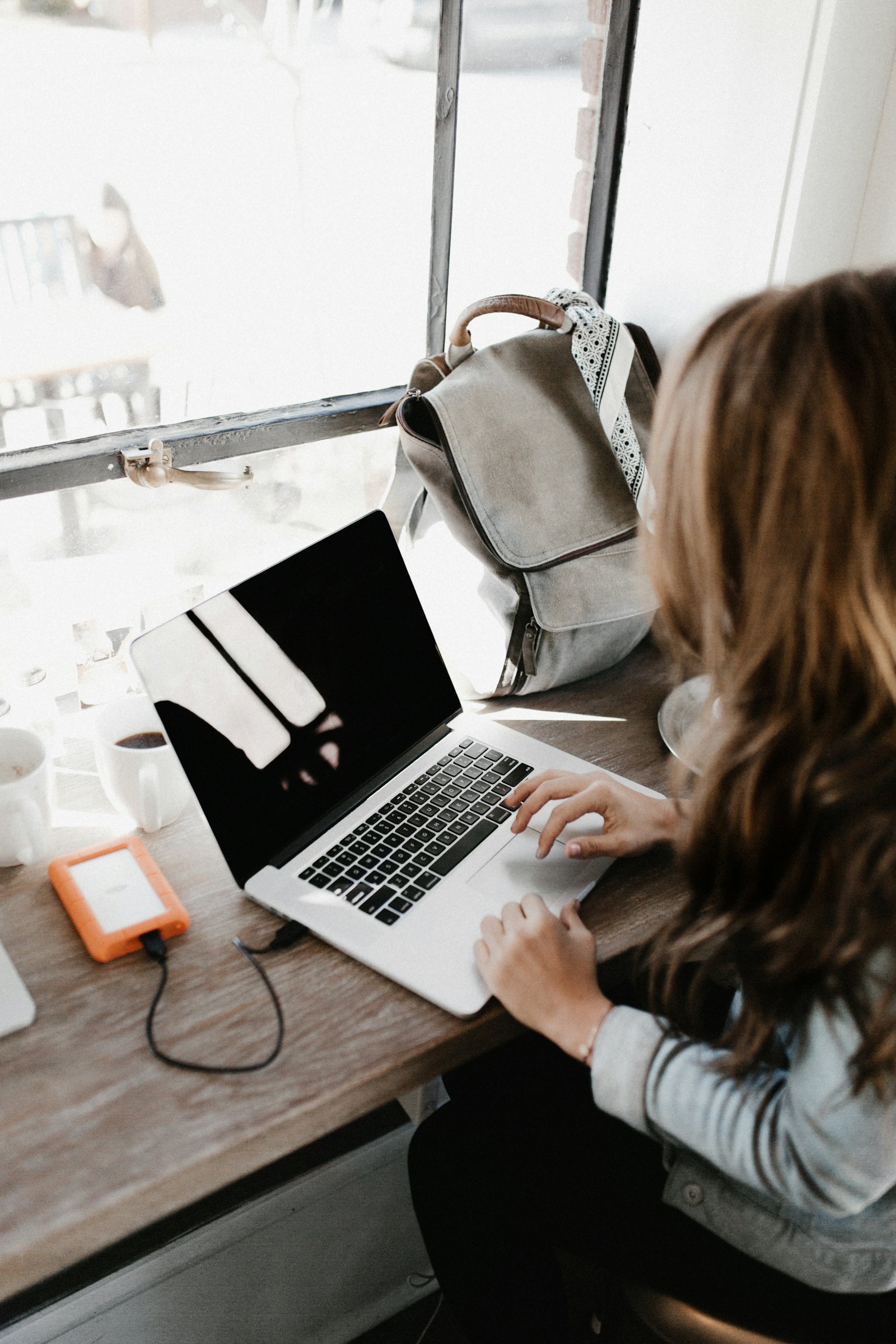 A creator working at a laptop